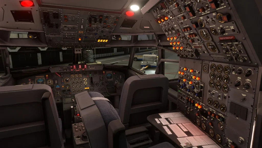 Vue nocturne complète du cockpit du Boeing 727 montrant les positions du commandant de bord, du copilote et du mécanicien navigant éclairées par l'éclairage des instruments.